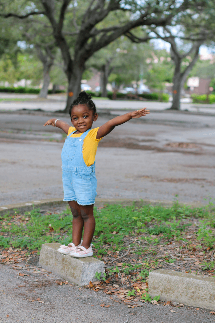 happy girl outside swinging her arms
