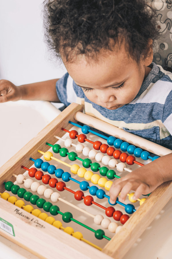 baby playing with abacus wooden beads toy
