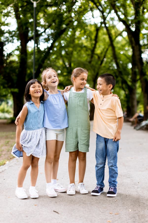 Group of Asian and Caucasian kids having fun in the park