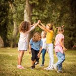 Large group of school kids having fun in nature.