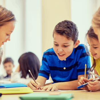 A group of young kids learn at school