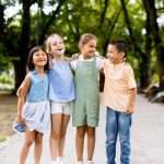 Group of asian and caucasian kids having fun in the park